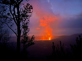 View of eruption and cloud lit up by hot lava as seen from the Crater Rim Trail at sunset.